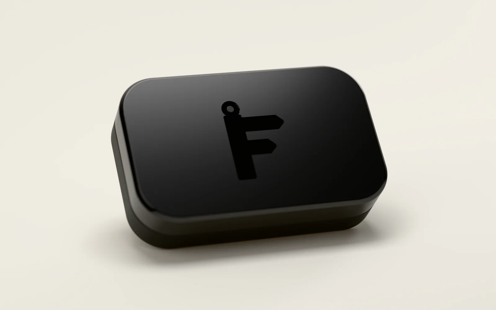 The Logbook, a small black device with Find a Drive's F, shaped like a fingerpost sign, pressed into its lid, the ring on top of the F lit